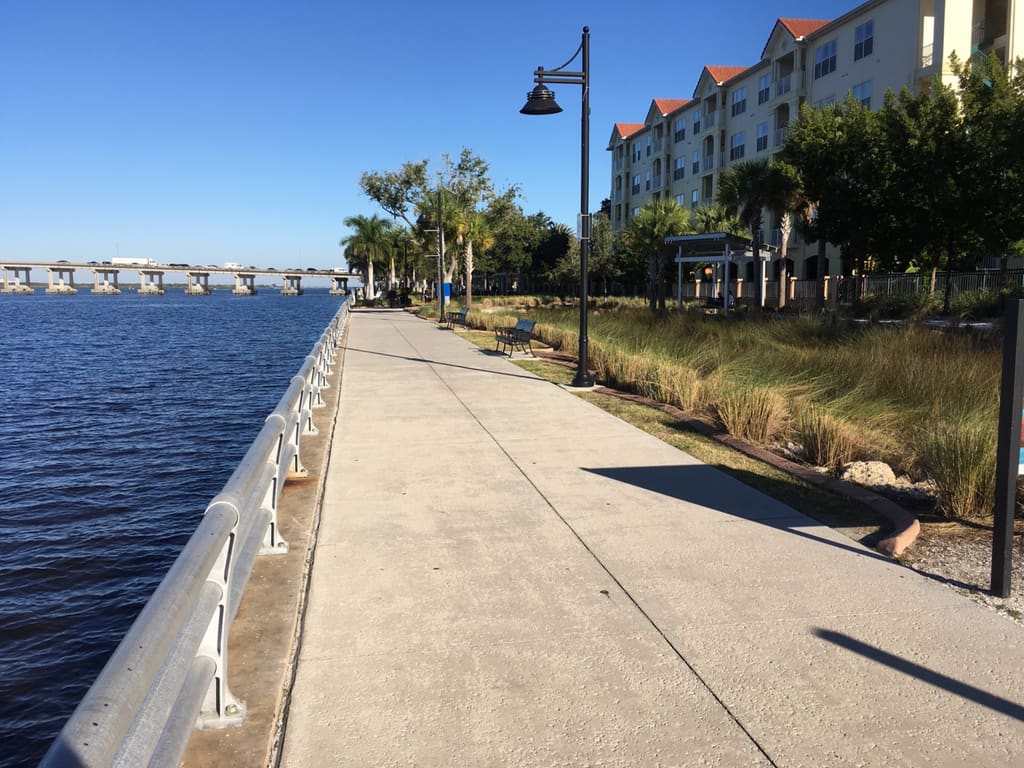A palm-lined promenade beside the Manatee River at Bradenton Riverwalk